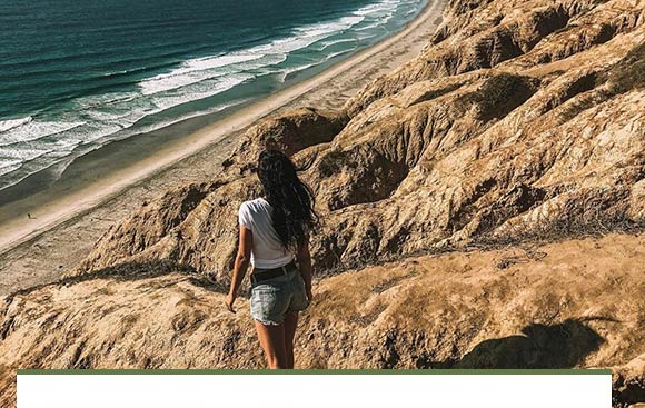 A woman walking on the beach.